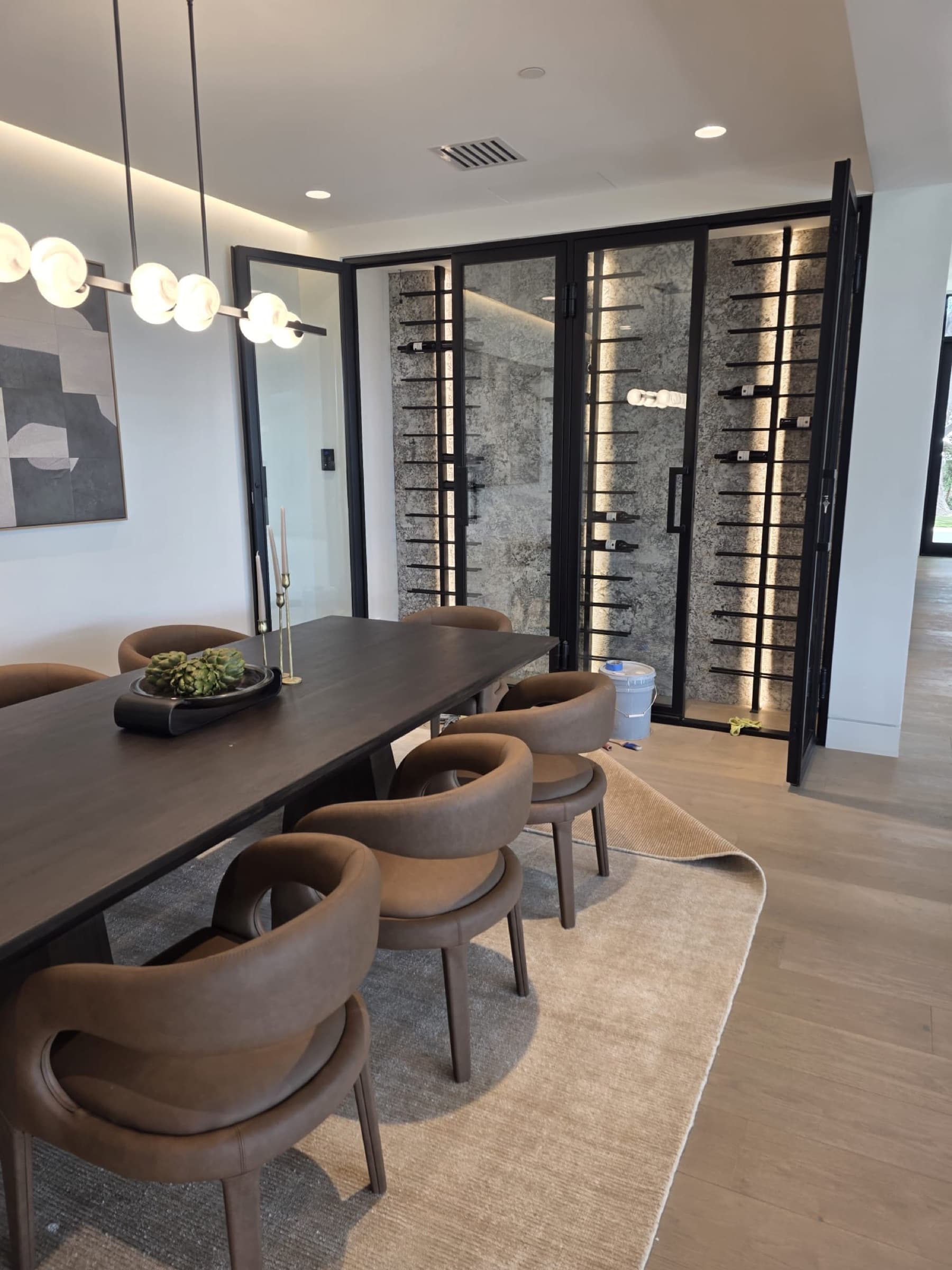 Custom wine room with stone surfaces and integrated lighting