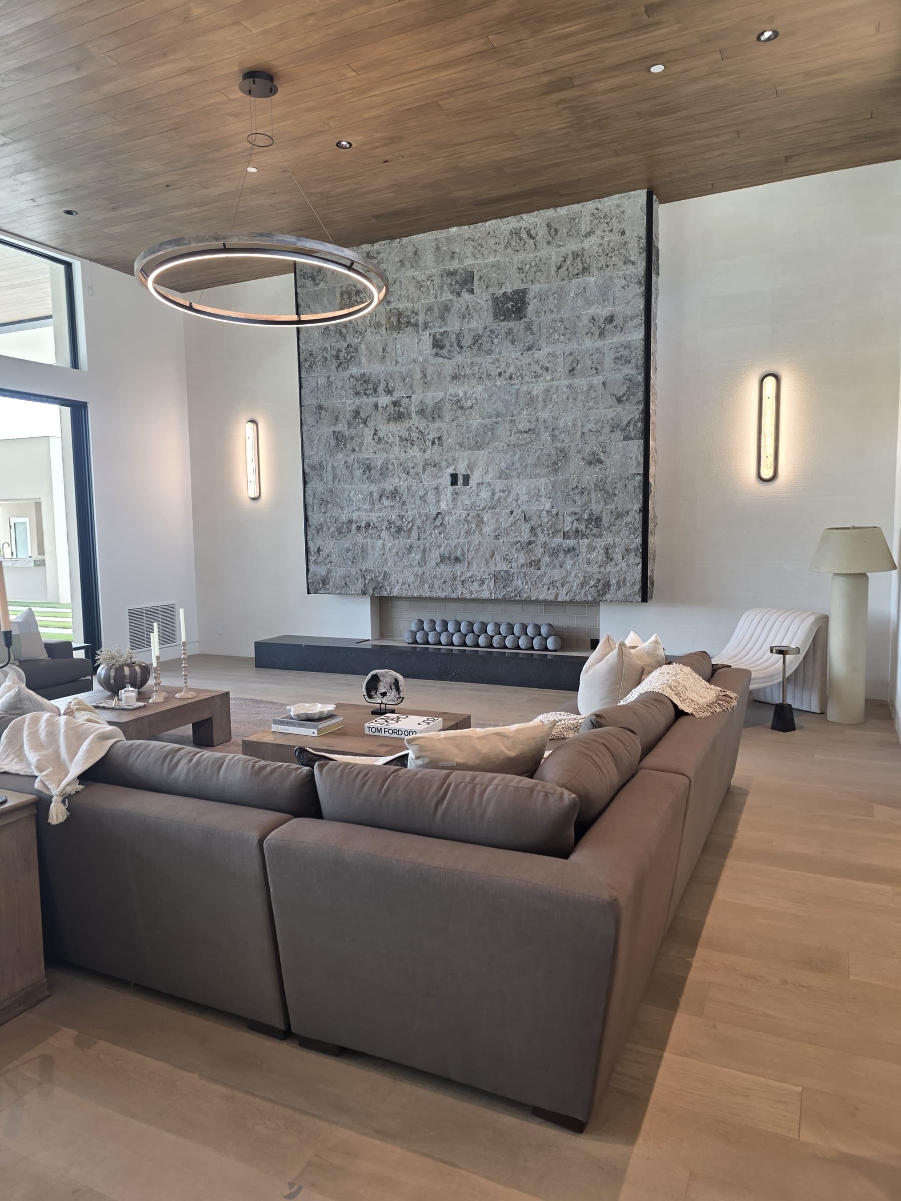 Floor-to-ceiling stone fireplace and wood ceiling in a Paradise Valley living room