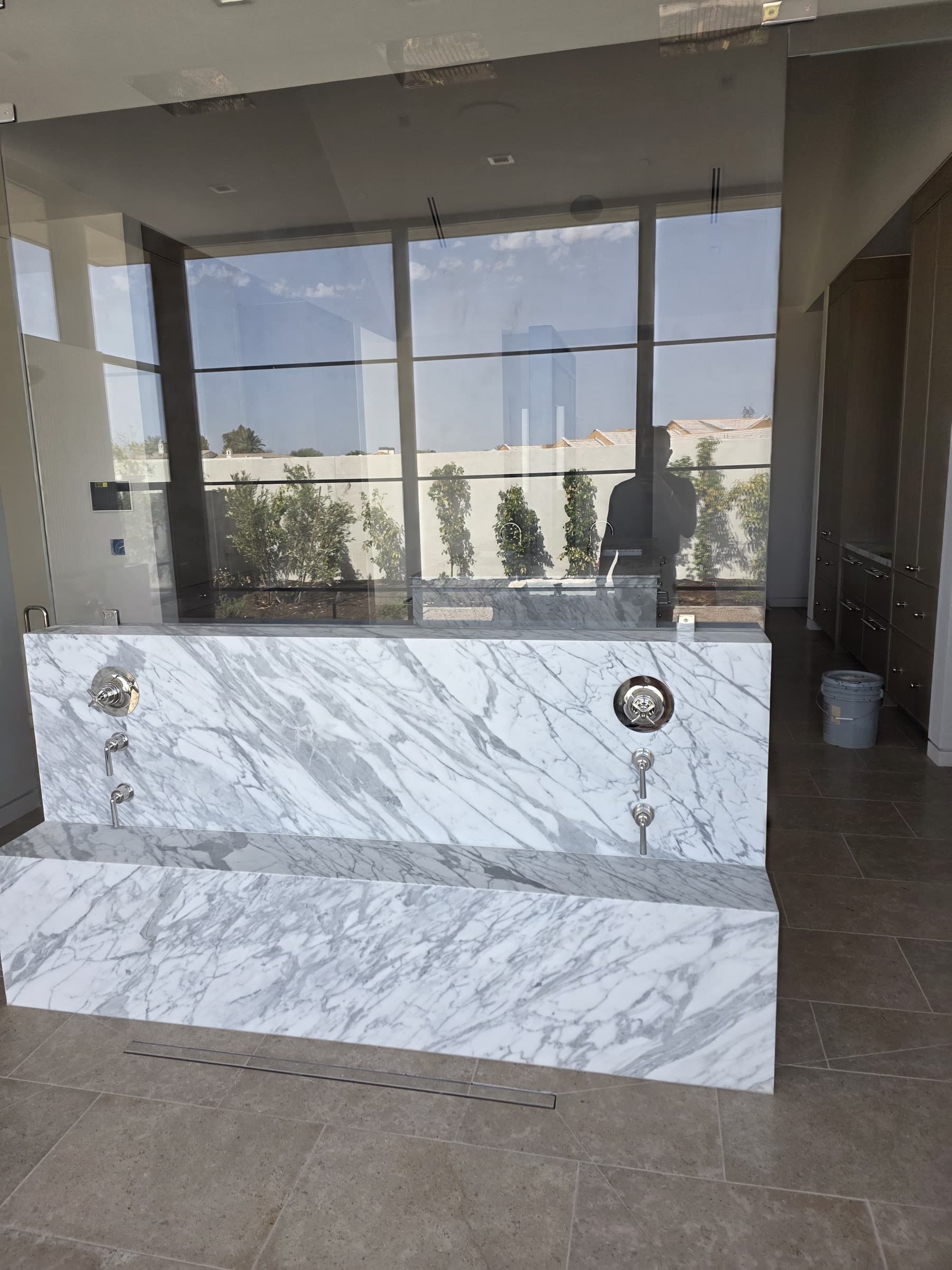 Custom marble soaking tub surround in a bright Arizona bathroom